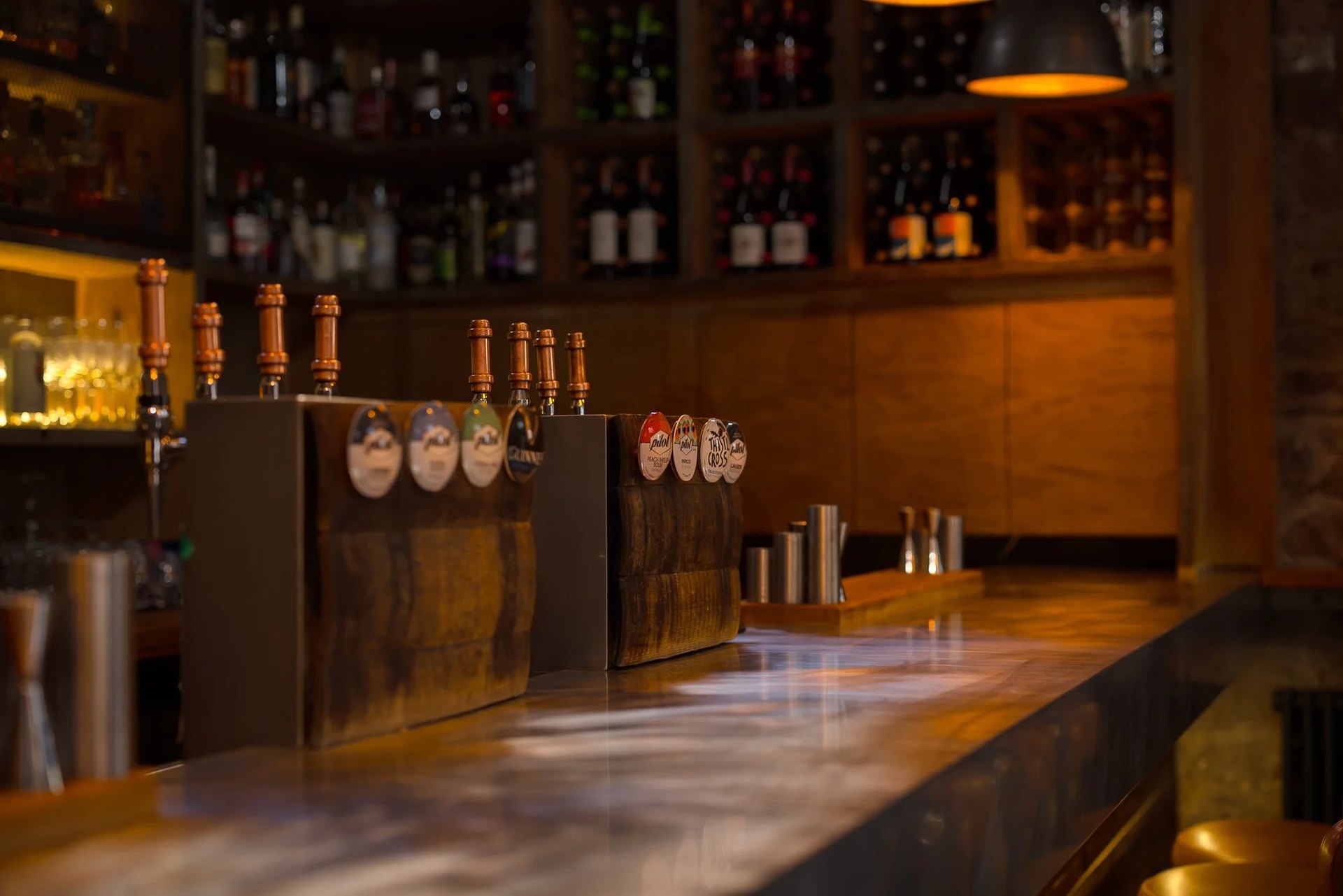 Beer taps set in old cask staves on the bar at The Devil’s Advocate