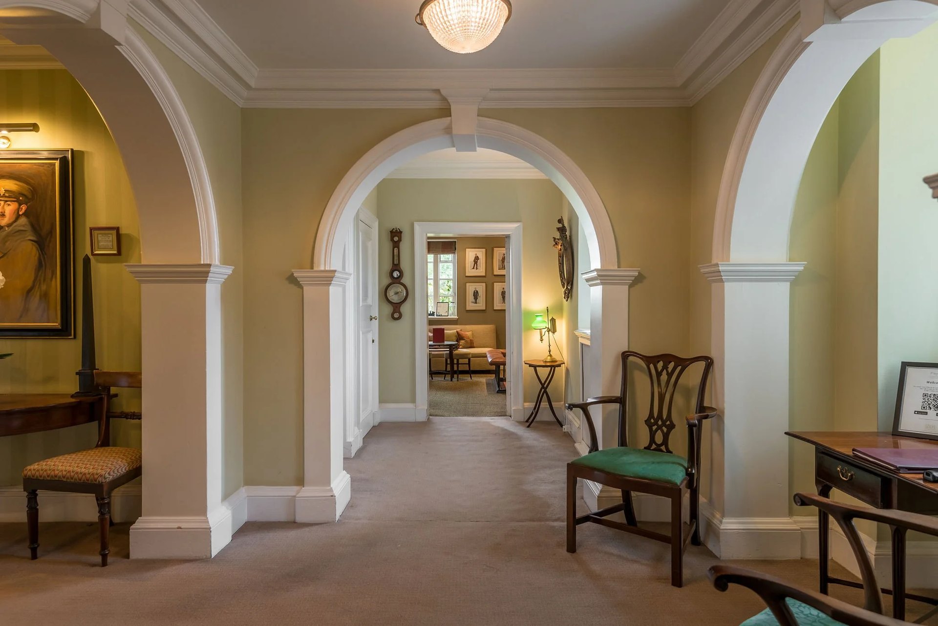 Arched hallways and antique chairs inside Greywalls
