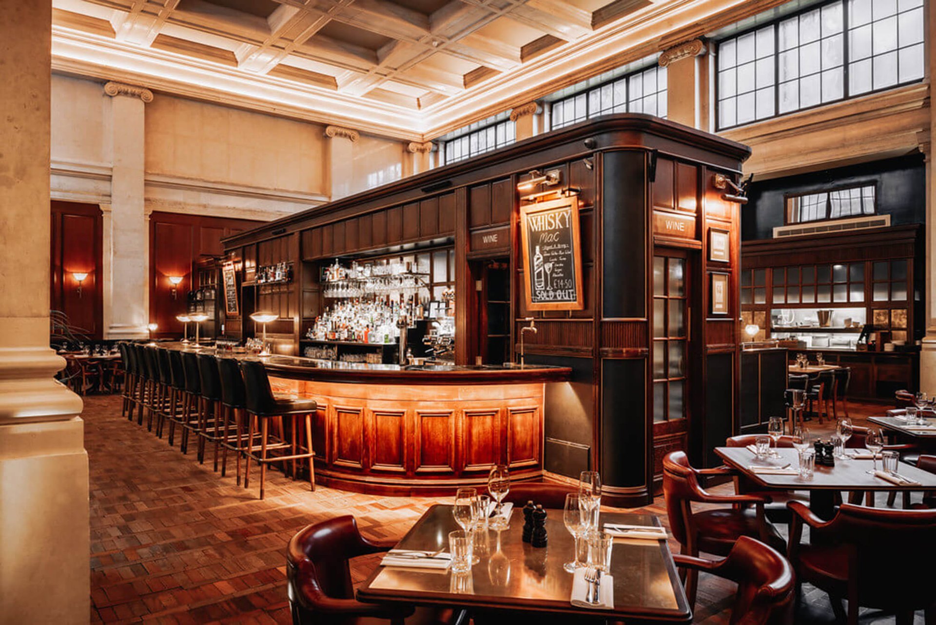 The panelled island bar at Hawksmoor Edinburgh under the old bank’s high windows