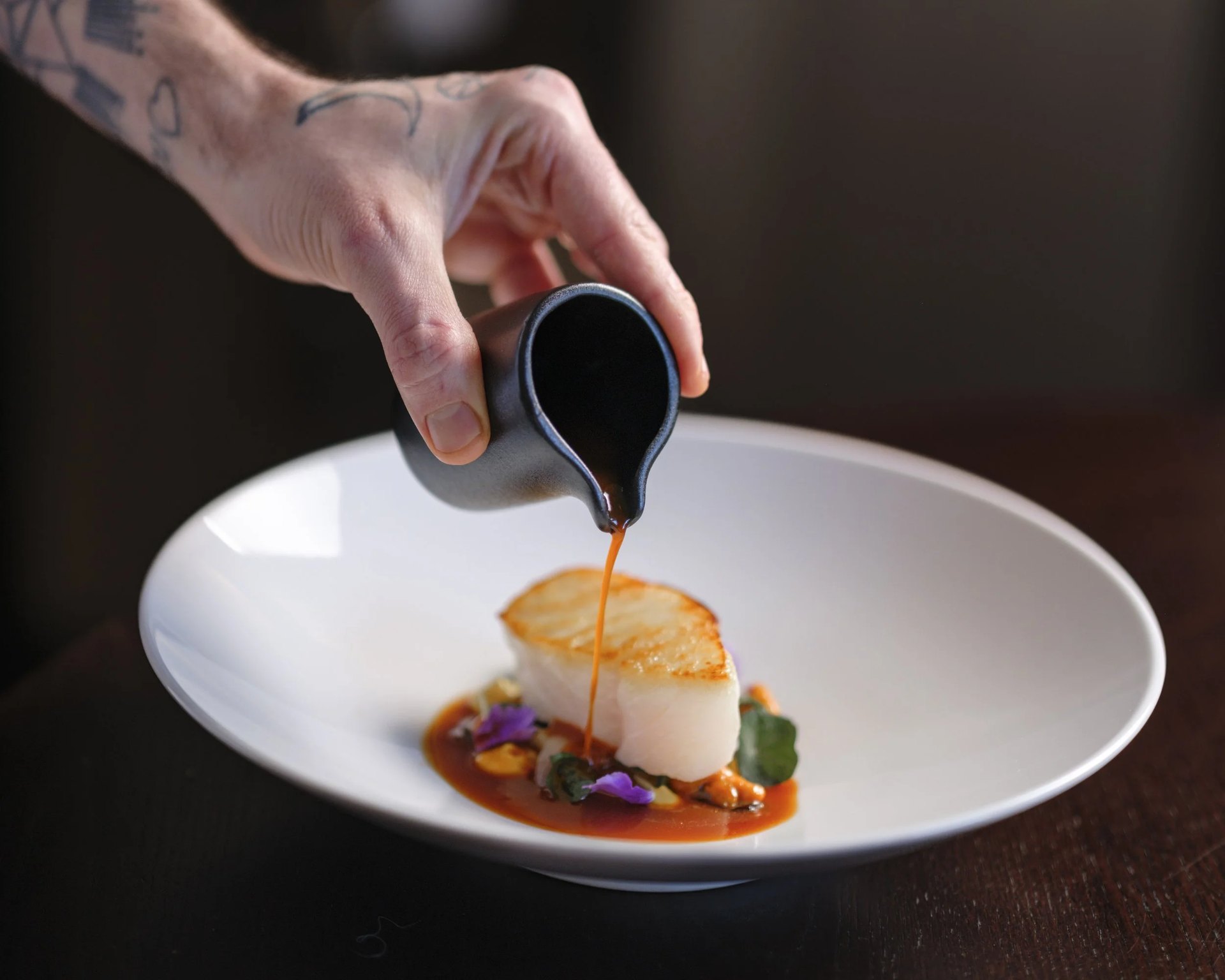 Sauce poured over a fillet of fish at 1925 at The Pompadour