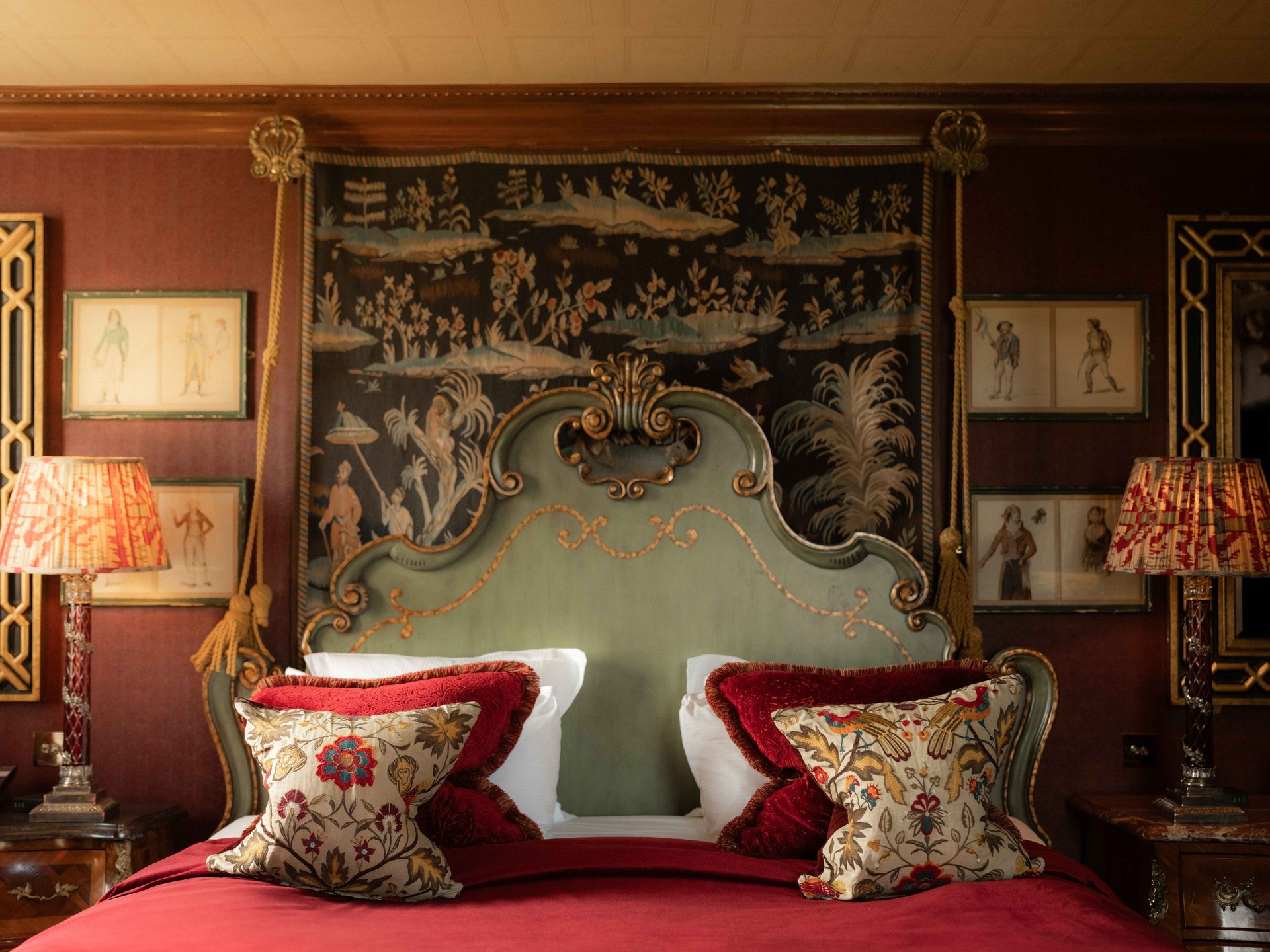 A bedroom at Prestonfield House: a carved green headboard, red velvet and a painted tapestry